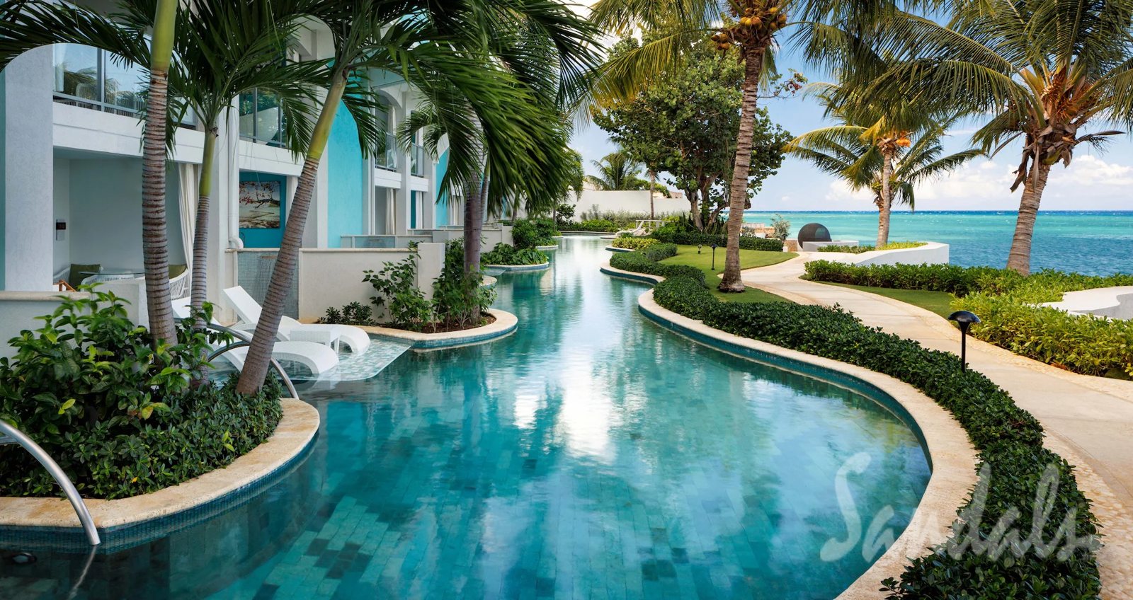 A winding, palm-lined pool at a Sandals all-inclusive resort in Jamaica. Photo: Sandals Resorts